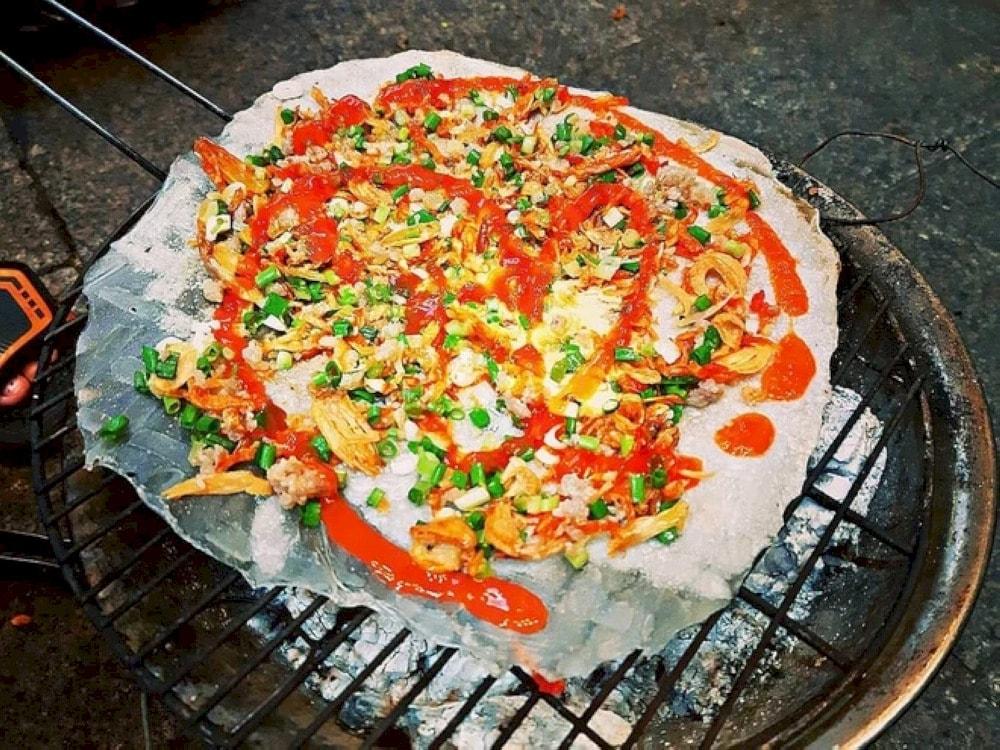 Banh Trang Nuong (Grilled Rice Paper) is a popular street food at Nguyen Hue Walking Street